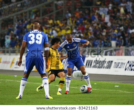 BUKIT JALIL, MALAYSIA - JULY 21: Chelsea\'s Ashley Cole (blue) controls the ball watched by Nicolas Anelka (39) in a game with Malaysia at the National Stadium on July 21, 2011 in Bukit Jalil, Malaysia.