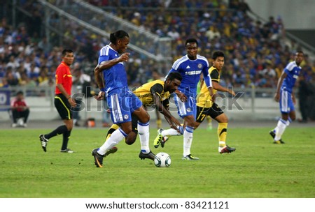 BUKIT JALIL, MALAYSIA - JULY 21: Chelsea\'s Didier Drogba (front, in blue) kicks the ball in a game against Malaysia at the National Stadium on July 21, 2011 in Bukit Jalil, Malaysia. Chelsea won 1-0.