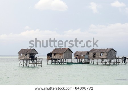 Sea gypsy home on huts built on stilts in the sea off Borneo Island.