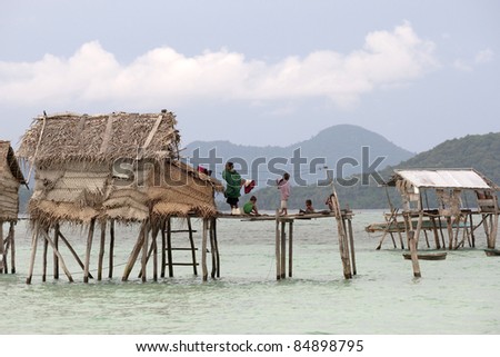 SABAH, MALAYSIA - SEPT 09: An unidentified Sea gypsy family rests at home in Sibuan Island on September 09, 2011 in Sabah, Malaysia. Many of the nomadic sea gypsies are stateless citizens living is desolated islands.
