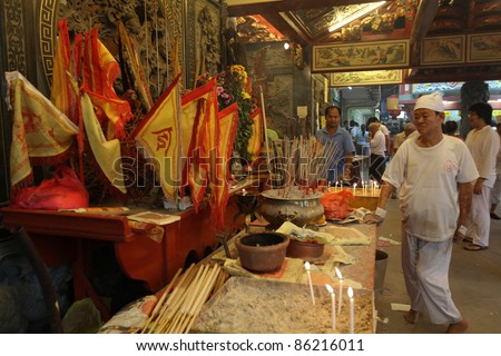 AMPANG, MALAYSIA – OCT 05: A temple care-taker maintains the altar of joss-sticks at the Lam Thian Kiong Temple during the annual ‘Nine Emperor Gods’ Festival on October 05, 2011 in Ampang, Malaysia.