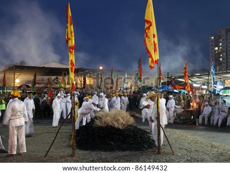 AMPANG, MALAYSIA – OCT 05:Taoist devotees prepare the fire-pit for the bare-footed fire-walk at the Lam Thian Kiong Temple during the annual ‘Nine Emperor Gods’ Festival on October 05, 2011 in Ampang, Malaysia.