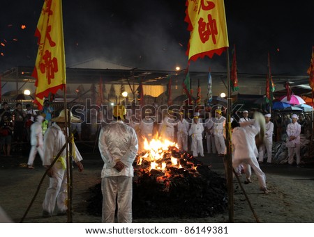 AMPANG, MALAYSIA – OCT 05: Devotees fan the charcoal fire in preparation for the fire-walk at the Lam Thian Kiong Temple during the annual ‘Nine Emperor Gods’ Festival on October 05, 2011 in Ampang, Malaysia.