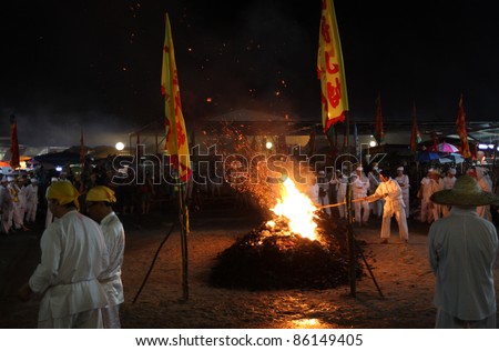 AMPANG, MALAYSIA – OCT 05: Devotees light the charcoal fire in preparation for the fire-walk at the Lam Thian Kiong Temple during the annual ‘Nine Emperor Gods’ Festival on October 05, 2011 in Ampang, Malaysia.