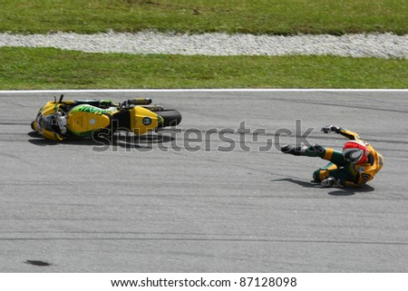SEPANG, MALAYSIA - OCTOBER 21: Moto2 rider Mattia Pasini falls at turn 15 during free practice at the Shell Advance Malaysian GP 2011 on October 21, 2011 at Sepang, Malaysia.