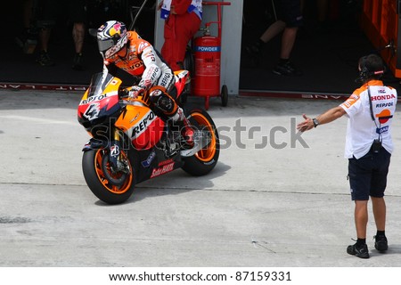 SEPANG, MALAYSIA- OCTOBER 21: MotoGP rider Andrea Dovizioso leaves the pit lane for the free practice session at the Shell Advance Malaysian Motorcycle GP 2011 on October 21, 2011 at Sepang, Malaysia.