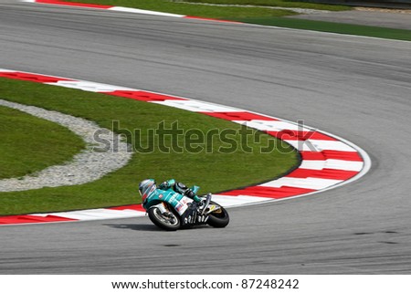 SEPANG, MALAYSIA - OCTOBER 22: Moto2 rider Hafizh Syahrin completes turn 1 at the qualifying race of the Shell Advance Malaysian Motorcycle GP 2011 on October 22, 2011 at Sepang, Malaysia.