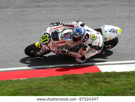 SEPANG, MALAYSIA - OCTOBER 23: Moto2 rider Michele Pirro warms up on race day of the Shell Advance Malaysian Motorcycle Grand Prix 2011 on October 23, 2011 at Sepang International Circuit, Malaysia.
