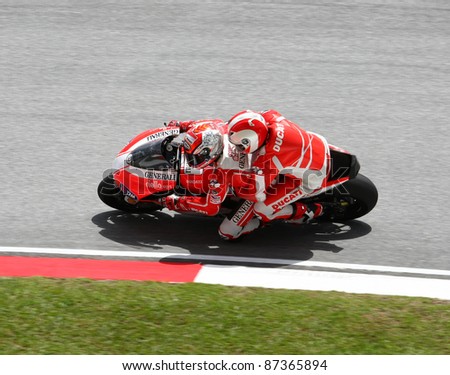 SEPANG, MALAYSIA - OCTOBER 23: A fan gets to ride on a two-seater Ducati motorcycle around the tracks at the Shell Advance Malaysian Motorcycle Grand Prix 2011 on October 23, 2011 at Sepang, Malaysia.