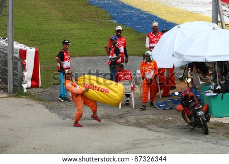 SEPANG, MALAYSIA - OCTOBER 23: Track staff stirs up fan support for Valentino Rossi, also known as 'The Doctor' on race day of the Malaysian Motorcycle GP 2011 on October 23, 2011 at Sepang, Malaysia.