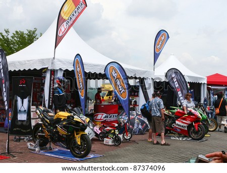 SEPANG - OCT 21: Motorcycle racing fans view the bikes and accessories on show at the Malaysian Motorcycle GP 2011 on Oct 21, 2011 at Sepang, Malaysia. The event attracted over 100,000 fans this year.