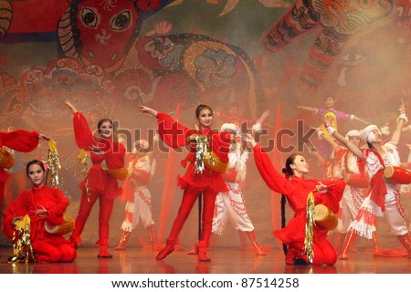 BEIJING, CHINA - NOVEMBER 16: Musicians perform the \'beat the waist drum\' dance on November 16, 2005 in Beijing, China. This dance is performed during harvest celebrations in rural China.