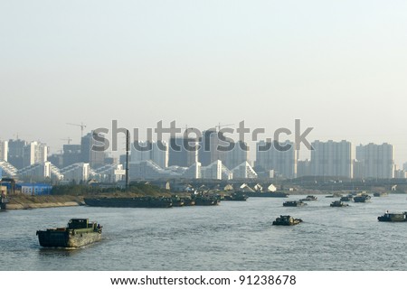 Barges transport goods on the Yangtze River in Nanjing city in China.