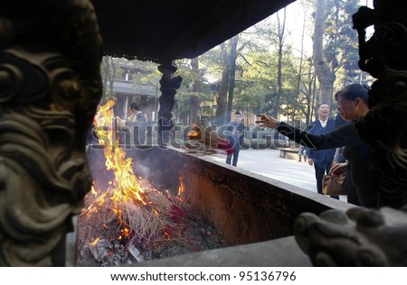 HANGZHOU, CHINA - NOVEMBER 26: Devotee lights up joss-sticks and pray at the Lingyin Temple on November 26, 2011 in Hangzhou, China. Buddhism is enjoying a revival in modern liberal China.