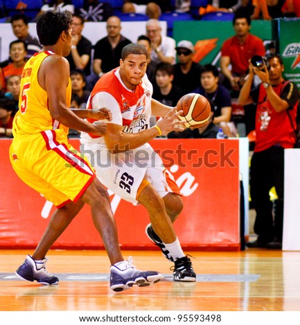 KUALA LUMPUR - FEBRUARY 19: Malaysian Dragons\' Brian Williams (33) dribbles in against the Singapore Slingers at the ASEAN Basketball League match on Feb 19, 2012 in Kuala Lumpur, Malaysia. Dragons won 86-71.