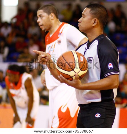 KUALA LUMPUR - FEBRUARY 19: Referee signals a foul at the ASEAN Basketball League match between Malaysian Dragons and Singapore Slingers on Feb 19, 2012 in Kuala Lumpur, Malaysia. Dragons won 86-71.