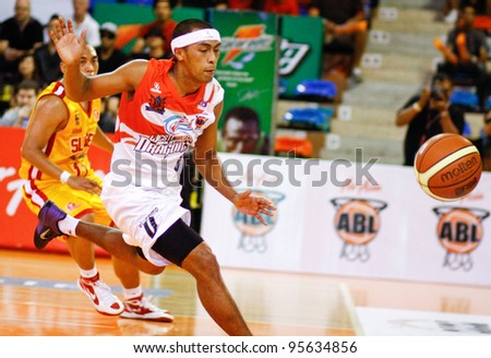 KUALA LUMPUR - FEBRUARY 19: Malaysian Dragons Guganeswaran (0) chases after a loose ball at the ASEAN Basketball League match against Slingers on February 19, 2012 in Kuala Lumpur. Dragons won 86-71.