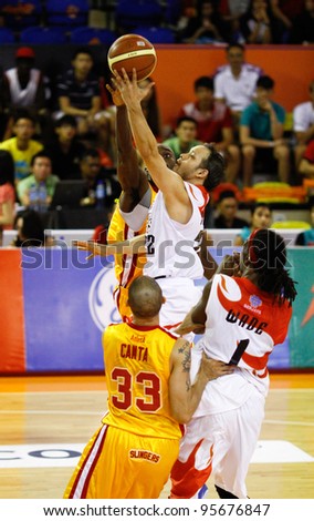KUALA LUMPUR - FEB 19:Malaysian Dragons Ernani Pacana\'s (22) goes in for a lay-up against the Singapore Slingers at an ASEAN Basketball League match on Feb 19, 2012 in Kuala Lumpur, Malaysia.  Dragons won 86-71.