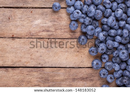 ripe blueberries on a wooden background