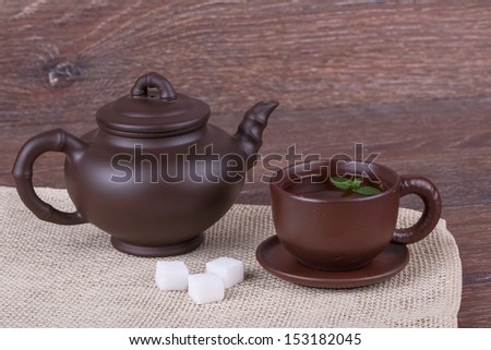 Green tea in clay cup on a wooden background