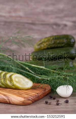 pickles with dill on a wooden background