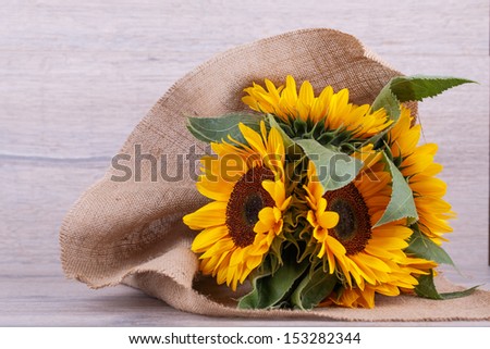 Bouquet of sunflowers on a wooden background.