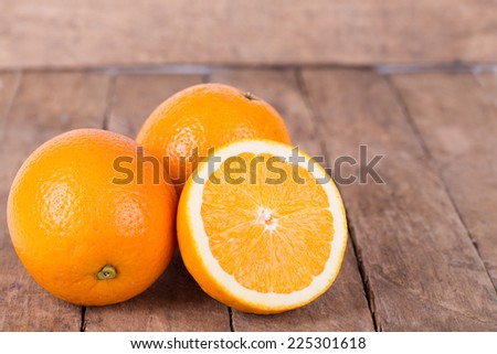 fresh, jucy,  orange on  a wooden background