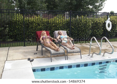 Two Bikini Blond Women Poolside