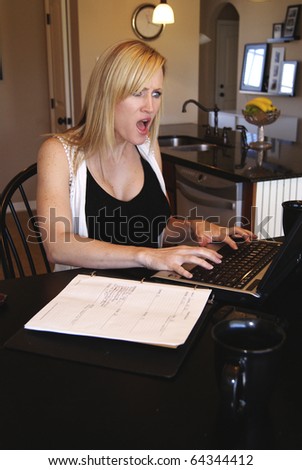 Shocked blond woman at home office