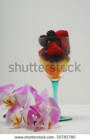 fruit cup with orchid blooms