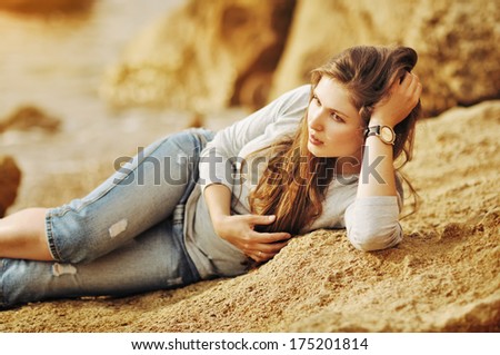 Portrait of the attractive girl on the seashore in country style. Spring theme. Warm colors