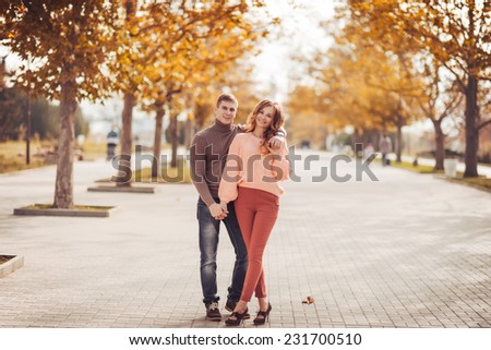 Young couple in love outdoor.Stunning sensual outdoor portrait of young stylish fashion couple posing in park in autumn