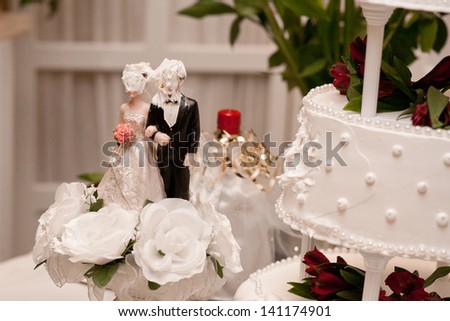 A wedding cake topper covered in cake frosting.