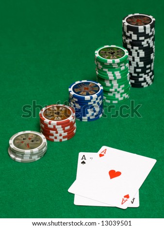 Pair of ace on green table with chips