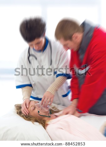 Paramedic and doctor reanimating a young woman - Picture in motion