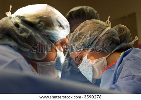 The faces of surgeons working on a patient (my wife) angle of this shot could suggest nearly anything related to medical operation.