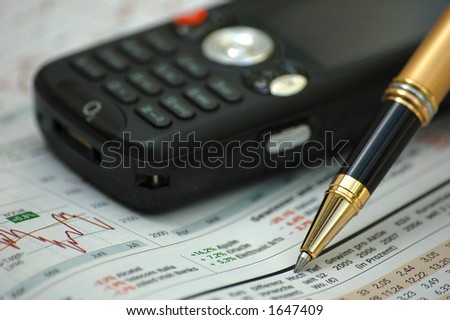 Golden pen on business magazine with modern mobile phone