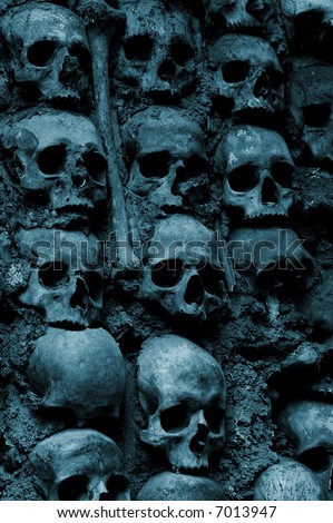 Wall full of skulls and bones in the bone chapel in Evora, Portugal (blue toned)