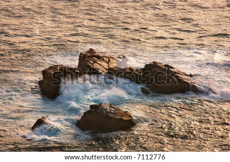 Waves crashing against the rocks, at Cabo da Roca, near Sintra, Portugal (The most western point in Europe) at sunset