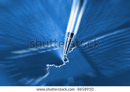Beautiful Pen pointing on a diagram on an finance newspaper (zoom effect)