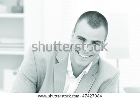 Young smiling business man giving eye contact