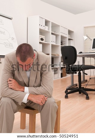 businessman looking depressed in his office