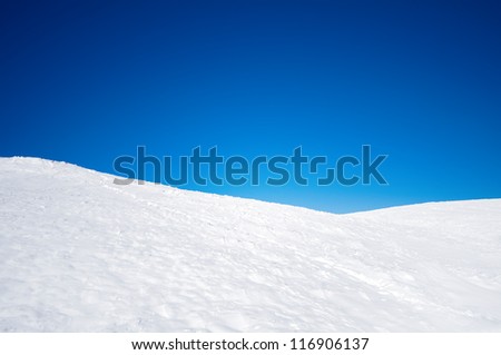 White Snowy Fields Under A Blue Sky