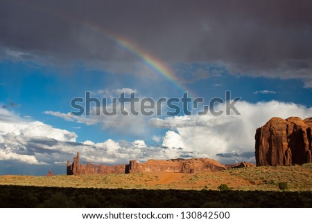 Rainbow appears after storm in Monument Valley desert USA