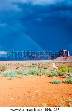 Storm clouds and rainbow over Monument Valley