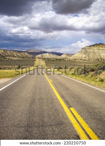 Utah roadway with sandstone formations in a storm