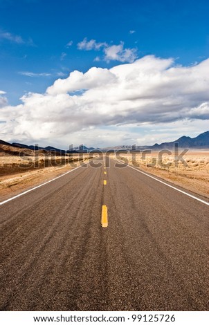 Road through desert in winter storm