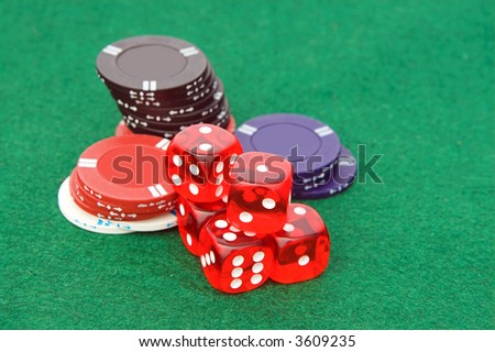 coins and dices on green table