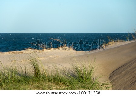 An isolated sand dune in a beach.