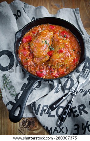 Chicken with tomatoes sauce in a skillet